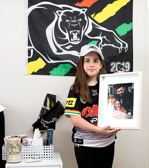 Eleven-year-old Rylee, Penrith, Holding a photo of the first time she met her absolute favourite player, Josh Mansour